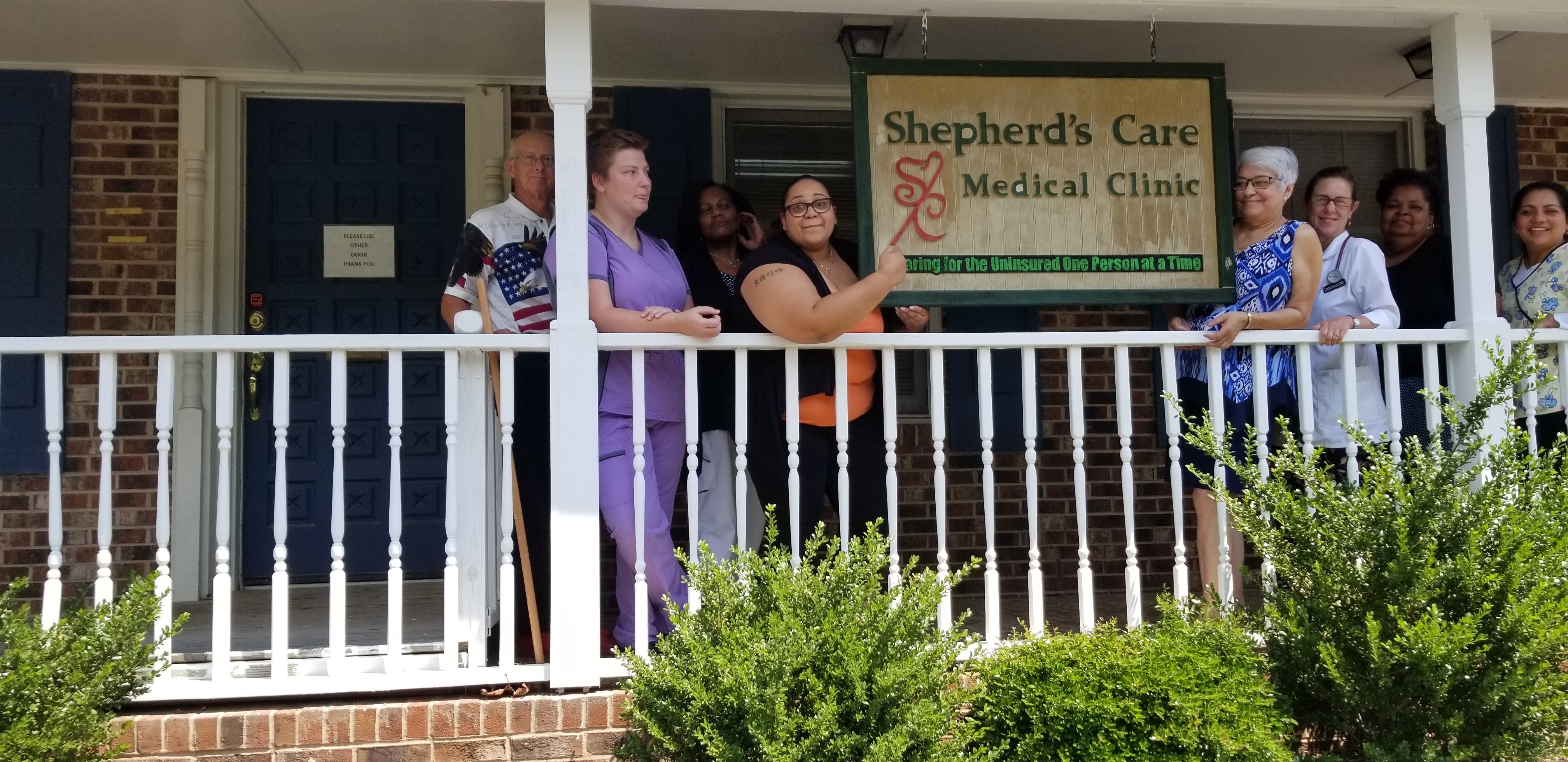 Employees standing in front of Shepherd's Care Medical Clinic
